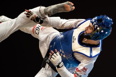 Jordan's Zaid Abdul Kareem and Uzbekistan's Ulugbek Rashitovin (red) compete in the men's -68Kg Taekwondo final event during the Hangzhou 2022 Asian Games in Hangzhou, in China's eastern Zhejiang province on September 27, 2023. (Photo by Philip FONG / AFP)