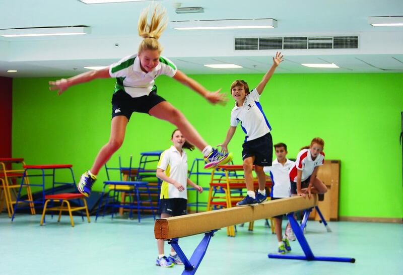 Year 7 pupils enjoy gymnastics during a PE class at Brighton College Abu Dhabi.  Pawan Singh / The National 