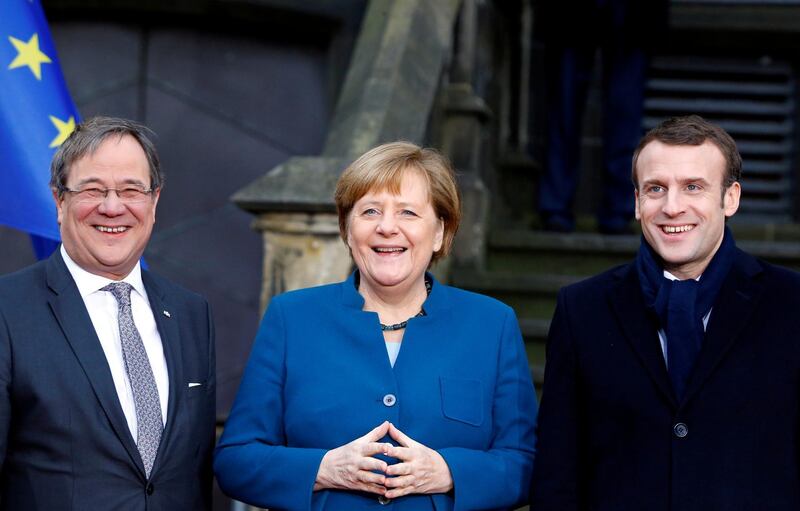 FILE PHOTO: Armin Laschet, federal premier of Germany's North Rhine-Westphalia, German Chancellor Angela Merkel and French President Emmanuel Macron attend a signing of a new agreement on bilateral cooperation and integration, known as Treaty of Aachen, in Aachen, Germany, January 22, 2019. REUTERS/Thilo Schmuelgen/File Photo
