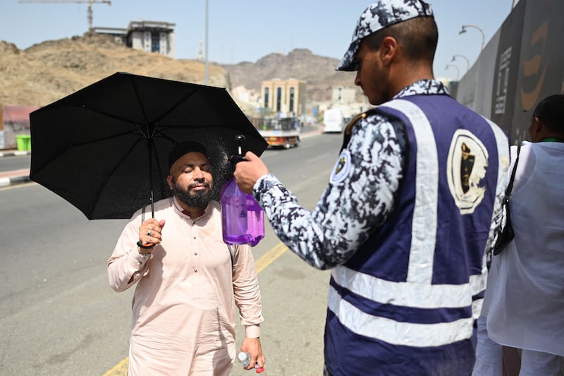 A member of the Saudi security forces sprays water on a pilgrim in Mina, near Makkah. AFP