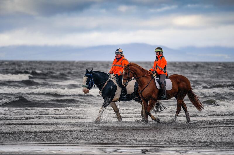 Members of the public exercise their horses on Irvine beach in Scotland. Jeff J Mitchell / Getty Images