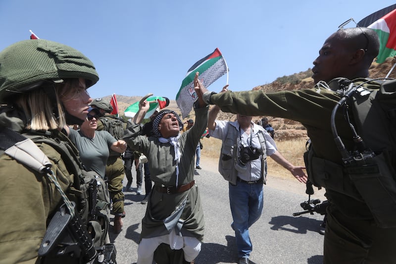 Israeli soldiers argue with Palestinians at Tayasee checkpoint, near the West Bank city of Tubas, on Monday. EPA