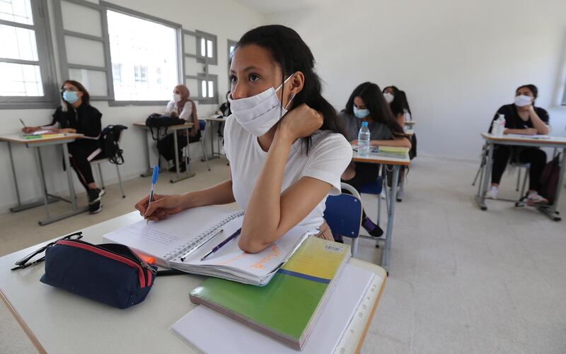 Baccalaureate students wearing face masks sit at a classroom at Riadh high school, in La Marsa in the suburbs of Tunis, Tunisia. EPA