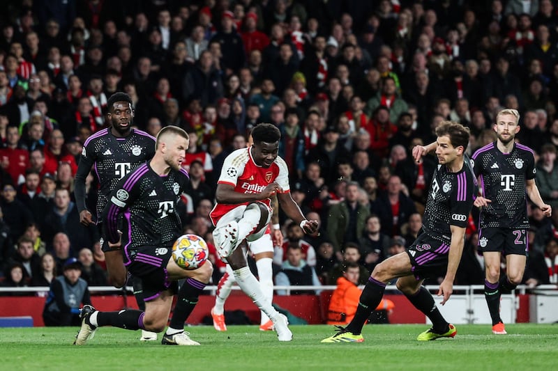 Arsenal midfielder Bukayo Saka shoots to score his team's first goal during the Champions League quarter-final first leg against Bayern Munich at Emirates Stadium, in London, on April 9, 2024. AFP