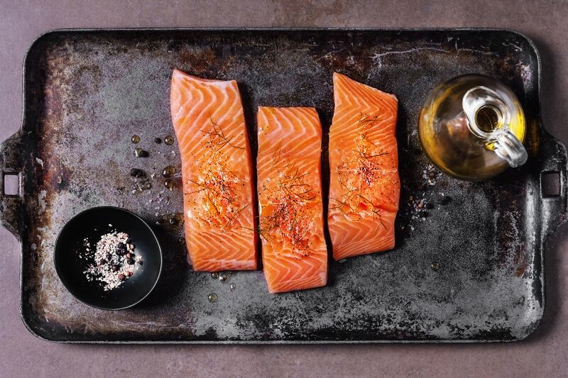 Salmon and honey boost tryptophan, an amino acid that supports sleep. Getty Images