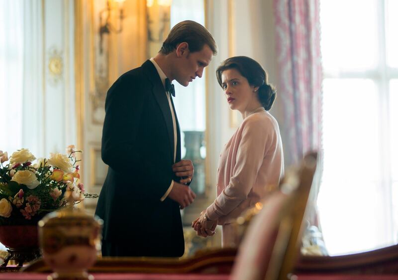 In this image released by Netflix, Claire Foy as Queen Elizabeth II, right, and Matt Smith as Prince Philip in a scene from "The Crown." Britain's Prince Philip stood loyally behind behind Queen Elizabeth, as his character does on Netflix's â€œThe Crown.â€ But how closely does the TV character match the real prince, who died Friday, April 9, 2021 at 99? Philip is depicted as a man of action in â€œThe Crown,â€ and he served with distinction in the navy in World War II. He was also an avid yachtsman and polo player. (Robert Viglasky/Netflix via AP)