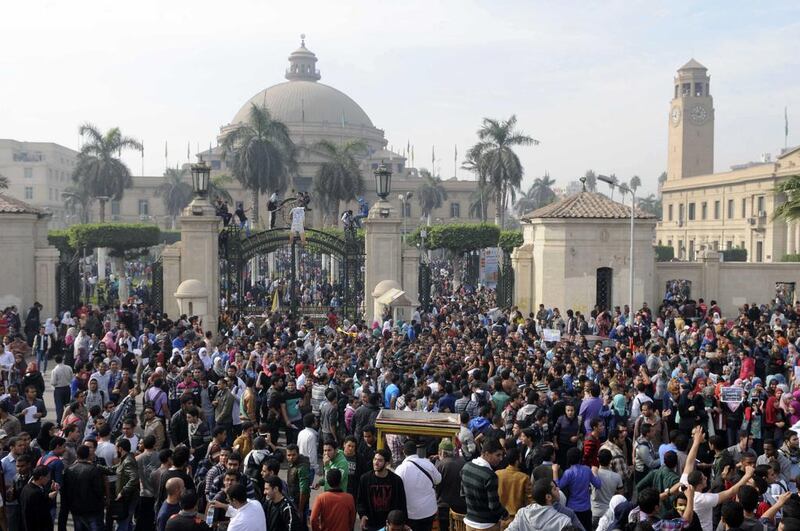 Student protesters and supporters of ousted Islamic President Mohammed Morsi gather outside the main gate of Cairo University on December 1. Mohammed Asad / AP




