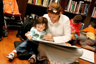 A mother reads a book to her child at Sharjah Art Museum. Photo Sharjah Art Museum

