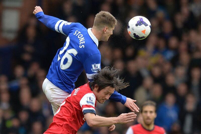 Everton defender John Stones rises above Arsenal midfielder Tomas Rosicky to win the ball during his side's win over Arsenal on Sunday. Paul Ellis / AFP / April 6, 2014