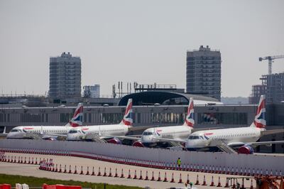 Passenger aircraft, operated by British Airways, a unit of International Consolidated Airlines Group SA (IAG), sit with their engines covered behind a newly-built temporary hoarding at the closed London City Airport, operated by London City Airport Ltd., in London, U.K. on Wednesday, April. 22, 2020. U.K. inflation slowed in March as the nation entered lockdown and oil prices continued to tumble. Photographer: Jason Alden/Bloomberg