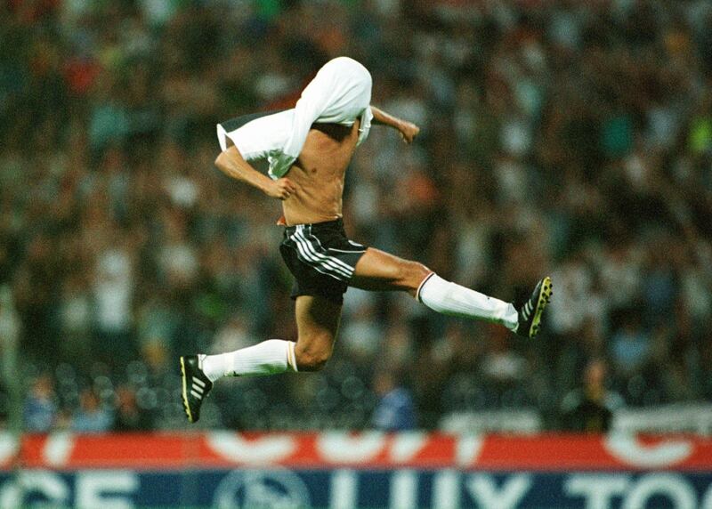 Germany's Mehmet Scholl celebrates scoring a goal by covering his head with his shirt and jumping in the air 
Germany v Spain 4-1 
International Friendly Match 
Hannover, Germany 
16/08/2000 
Photo: Michael Kolvenbach 
© Sporting Pictures (UK) Ltd 
Tel: 020 7405 4500 
Fax: 020 7831 7991 
www.sporting pictures.com 
Mandatory Credit: Action Images / Sporting Pictures *** Local Caption *** 91010055