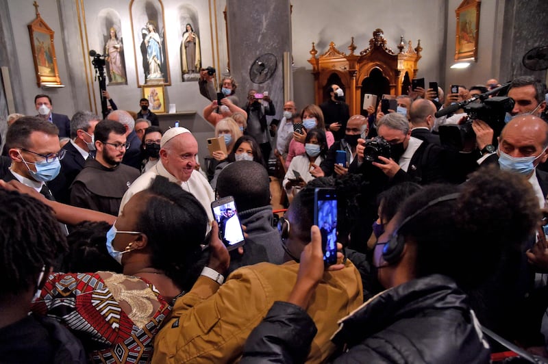 Worshippers take pictures of Pope Francis. AFP