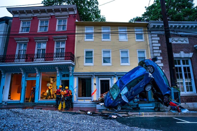 Rescue personnel examine damage on Main Street after a flash flood rushed through the historic town of Ellicott City, Maryland, USA, 27 May 2018. The National Weather Service stated as much as 9.5 inches of rain fell in the area.  Jim Lo Scalzo / EPA