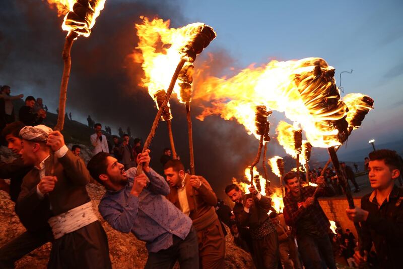 People participate in a torch procession during Nowruz celebrations in Akre, Aqrah City in Duhok, Kurdistan Region, northern Iraq.  EPA