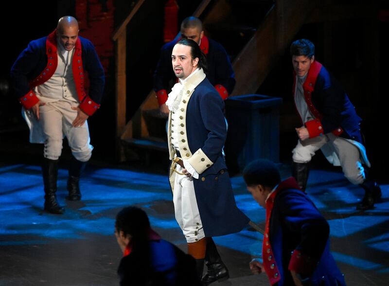 FILE - In this June 12, 2016 file photo, Lin-Manuel Miranda and the cast of "Hamilton" perform at the Tony Awards in New York.  Next year, you'll be able to see the original Broadway cast of â€œHamiltonâ€ perform the musical smash from the comfort of a movie theater. The Walt Disney Company said Monday, Feb. 3, 2020, it will distribute a live capture of Lin-Manuel Miranda's show in the United States and Canada on Oct. 15, 2021. (Photo by Evan Agostini/Invision/AP, File)