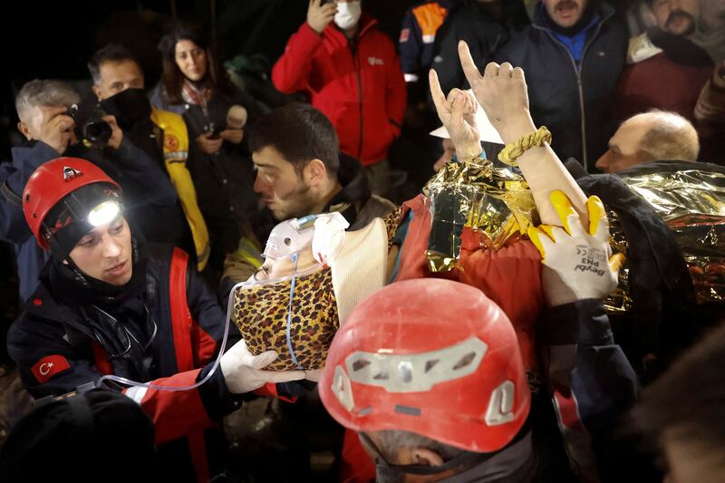 Rescuers carry Fatma, 15, who was pulled out from the rubble in Hatay, Turkey. Reuters