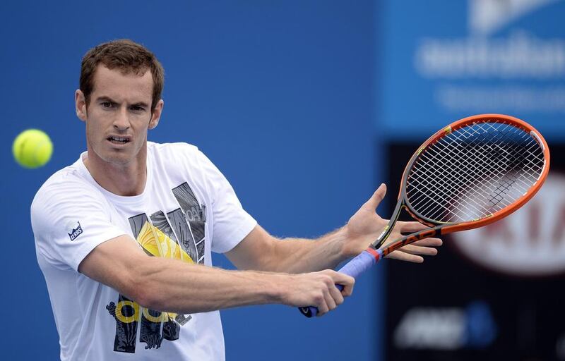 Andy Murray returns the ball during practice on Sunday at the Australian Open in Melbourne. The Scot wants to build on his memorable Wimbledon title from last year. Franck Robichon / EPA

