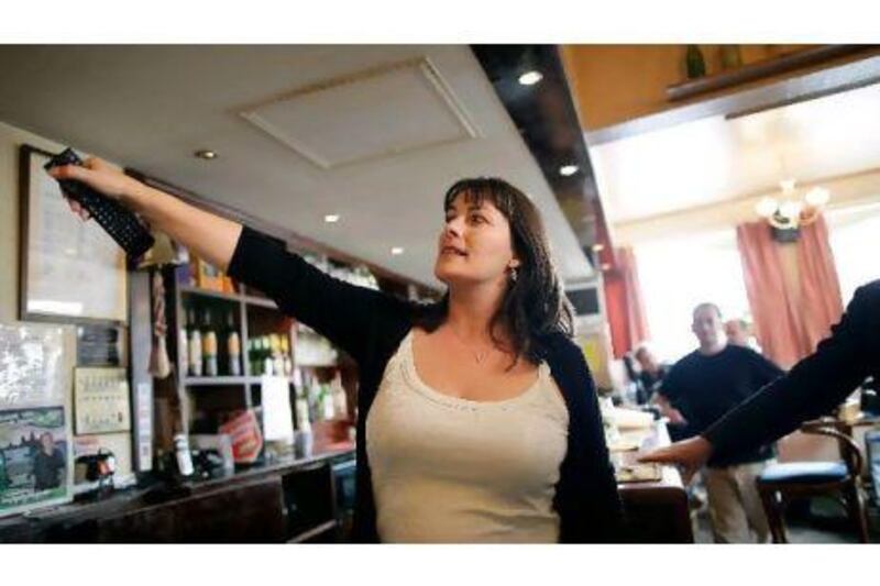 Karen Murphy turns on the television inside her pub in Portsmouth, England, after the court ruled in her favour.