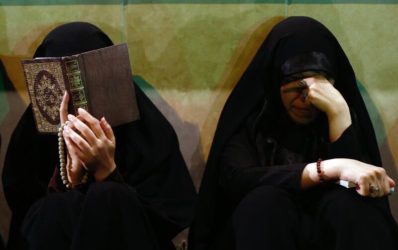 Iranian women pray around the graves at the Behesht-Zahra cemetery, in southern Tehran.  EPA