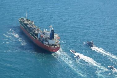 A seized South Korean-flagged tanker is escorted by Iranian Revolutionary Guard boats in the Arabian Gulf, January 4, 2021.  (Tasnim News Agency via AP)