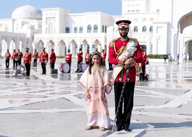ABU DHABI, UNITED ARAB EMIRATES. 2 DECEMBER 2019. 
Afra Al Mansoori poses next to a Abu Dhabi’s Police band member during UAE’s National Day celebrations at Qasr Al Watan.
(Photo: Reem Mohammed/The National)

Reporter:
Section: