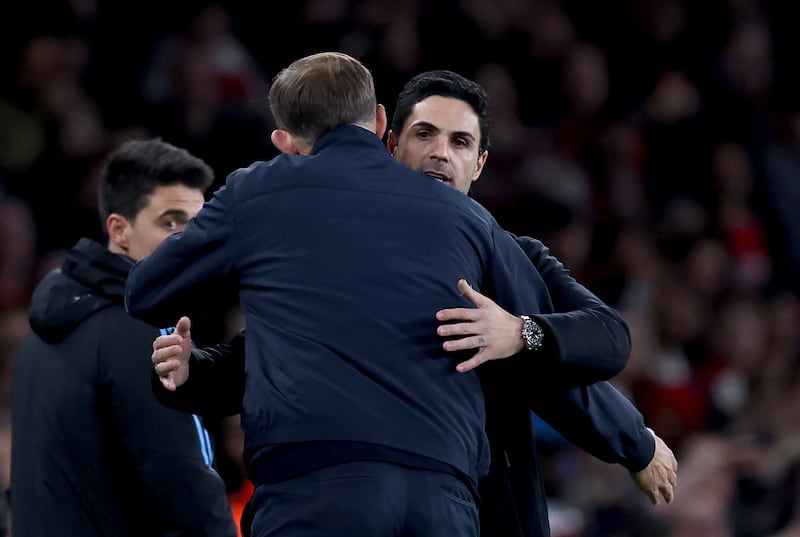 Arsenal manager Mikel Arteta and Bayern manager Thomas Tuchel embrace at full time. EPA
