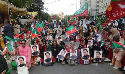 Supporters of Pakistan Tehreek-e-Insaf (PTI) party display portraits of the party's founder and convicted former Prime Minister Imran Khan as they attend a protest demanding his release, in Karachi, Pakistan, June 2. EPA
