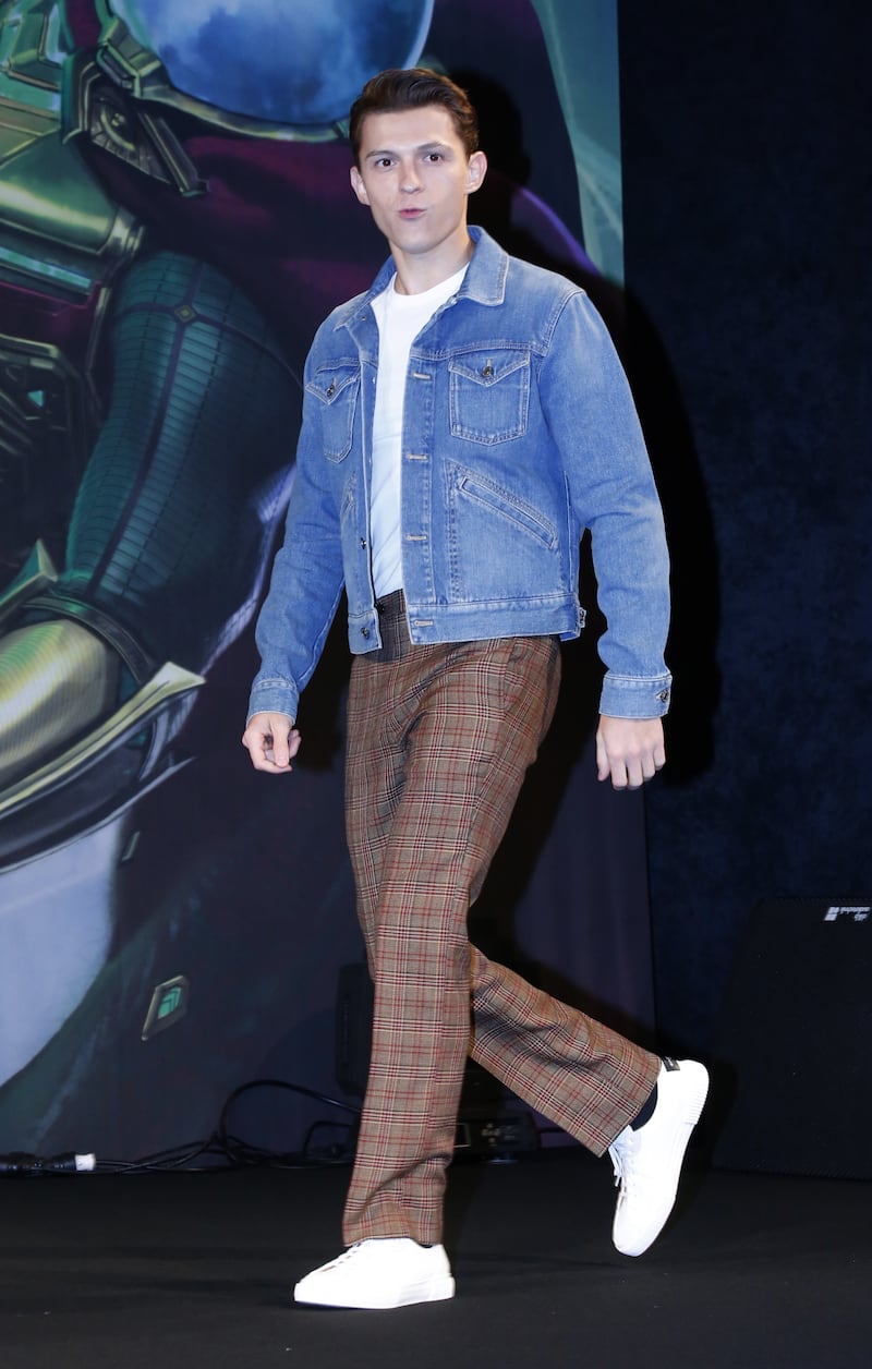 Tom Holland, in checked trousers and a denim jacket, arrives for a 'Spider-Man: Far From Home' press conference in Seoul on July 1, 2019. EPA