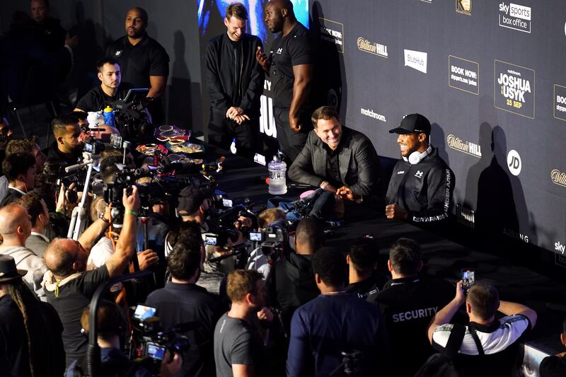Eddie Hearn with Anthony Joshua during the press conference at the Tottenham Hotspur Stadium. PA