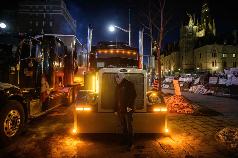 A lorry driver protesting outside the Canadian Parliament in Ottawa. Prime Minister Justin Trudeau invoked emergency powers to end to trucker protests against Covid-19 rules, after police arrested 11 people with a ‘cache of firearms’ blocking a border crossing with the US. AFP
