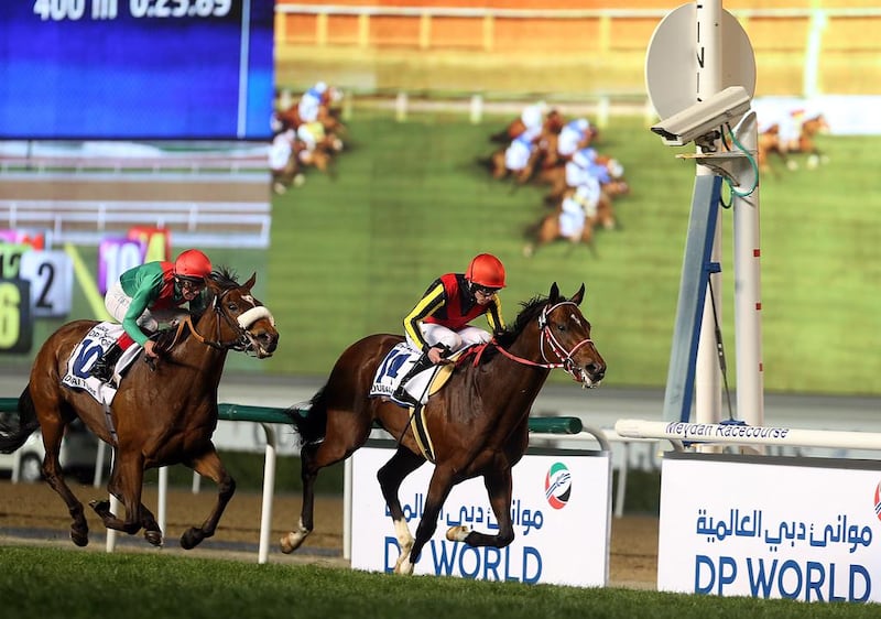 Jockey Ryan Moore, right, riding Real Steel wins the Race 7 Dubai Turf sponsored by DP World during the Dubai World Cup at the Meydan Racecourse in Dubai.  Satish Kumar / The National