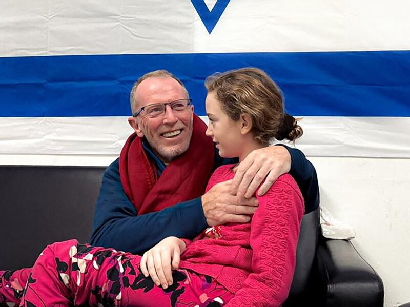 Emily Hand embracing her father at a hospital in Israel after she was released by Hamas. AFP
