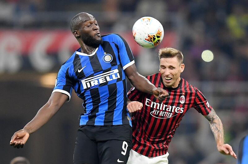 Inter Milan's Romelu Lukaku in action with AC Milan's Lucas Biglia. Reuters