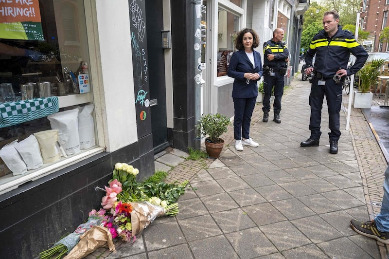 Amsterdam's Mayor Femke Halsema (C) speaks with officials as they look at floral tributes placed on a street in Amsterdam on May 21, 2021, following a stabbing attack overnight in an area of bars and restaurants near the capital's museum quarter. Dutch police were on May 22, 2021 investigating a spate of stabbings in Amsterdam in which one person died and four were injured, but said there were no indications of terrorism.
 - Netherlands OUT
 / AFP / ANP / Evert Elzinga
