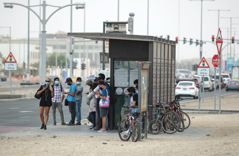 Commuters wait for their bus during gusty winds in Khalifa City, Abu Dhabi on the 28th of April, 2021. Victor Besa / The National.