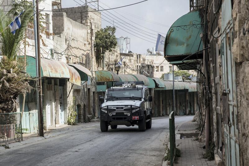 A police vehicle with iron meshing to protect against stone throwing rumbled by in quick succession Wednesday October 18,2018 on a Hebron street whose Palestinian shops have long since been welded shut by the Israeli military neighborhood. (Photo by Heidi Levine for The National).