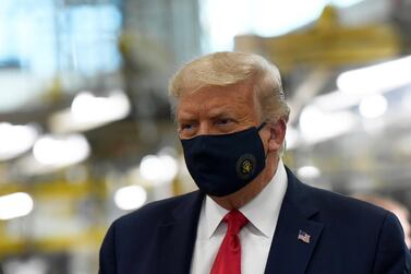 President Donald Trump wears a mask as he tours the Whirlpool Corporation facility in Clyde, Ohio, August 6 2020. AP Photo