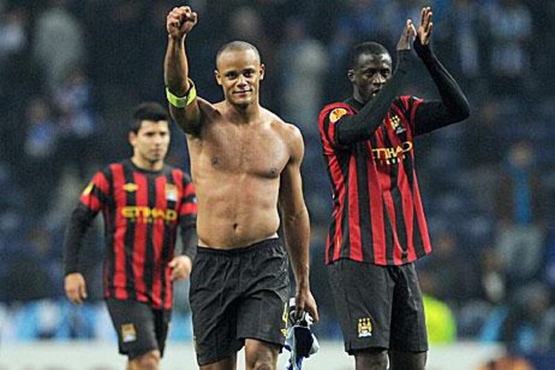 Vincent Kompany, left, and Yaya Toure, right, celebrate victory in Porto.