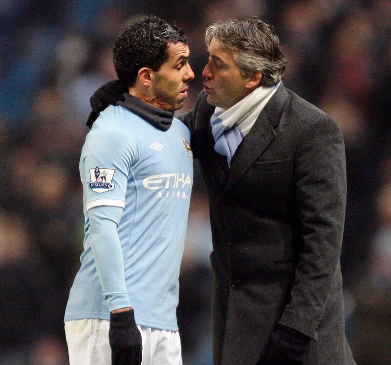 FILE - This Saturday Dec. 4, 2010 file photo shows Manchester City's Carlos Tevez, left, speaking with manager Roberto Mancini after being substituted during his team's English Premier League soccer match against Bolton Wanderers at The City of Manchester Stadium, Manchester, England. Manchester City has refused Carlos Tevez's request to be sold to another club, which the Premier League team said was motivated by the Argentina striker's desire for an improved contract. With less than three weeks until the January transfer window, City said Sunday Dec. 12, 2010 that Tevez had submitted a written request to leave. (AP Photo/Jon Super) NO INTERNET/MOBILE USAGE WITHOUT FOOTBALL ASSOCIATION PREMIER LEAGUE(FAPL)LICENCE. EMAIL info@football-dataco.com FOR DETAILS *** Local Caption ***  LON103_Britain_Man_City-Tevez.jpg