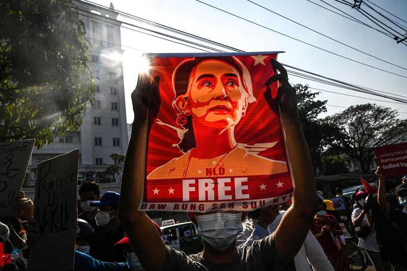 (FILES) In this file photo taken on February 15, 2021, a protester holds up a poster featuring Aung San Suu Kyi during a demonstration against the military coup in front of the Central Bank of Myanmar in Yangon. Myanmar's deposed leader Aung San Suu Kyi has been hit with fresh corruption charges, state-run media reported on June 10, 2021. - 
 / AFP / STR
