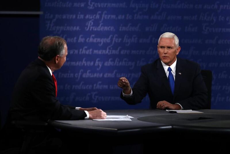 Mike Pence, the Republican vice presidential nominee, right, speaks as Tim Kaine, the Democratic vice presidential nominee, listens during the 2016 vice presidential debate at Longwood University in Farmville, Virginia, on October 4, 2016. Andrew Harrer/Bloomberg