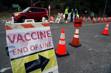 Drivers with a vaccine appointment enter the vaccination site at Dodger Stadium in Los Angeles on January 30, 2021. AP