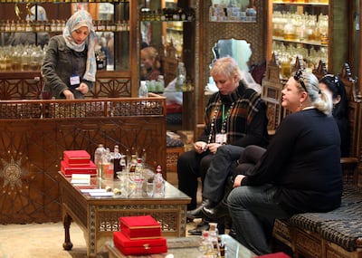 Tourists wait as their perfumed oil is prepared at a perfume shop near the Giza pyramids. January 11, 2009. Photo: Victoria Hazou for the National