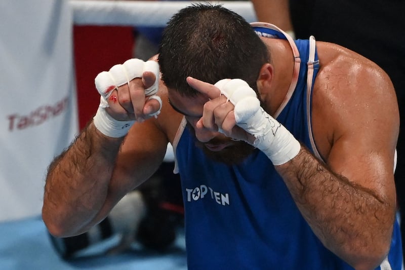 France's Mourad Aliev gestures in the ring.