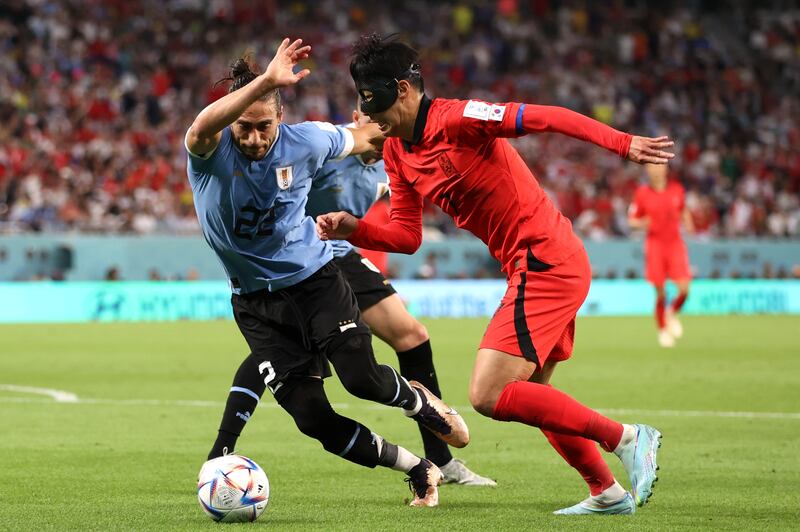 Son Heung-min battles for possession with Martin Caceres. Getty