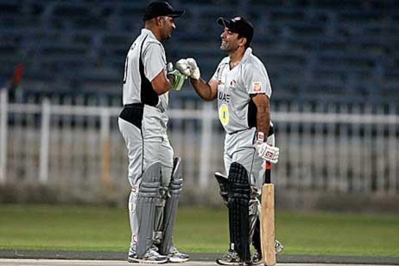 Hashmi, left, and Tauqir share notes during their 178-run stand.