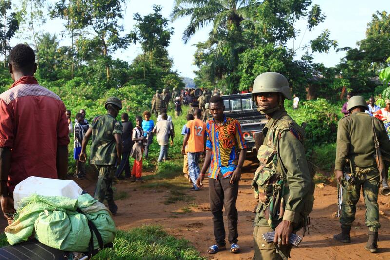 In this photo taken Friday, Oct 5, 2018, Congolese Soldiers patrol in an area civilians were killed by The Allied Democratic Forces rebels in Beni, Eastern Congo.  Congoâ€™ military said Sunday Oct. 21, 2018, that rebels attacked an Ebola treatment centre in Beni, leaving over a dozen civilians dead and abducted about a dozen children, which could force crucial virus containment efforts to be suspended in the area. (AP Photo/Al-hadji Kudra Maliro)