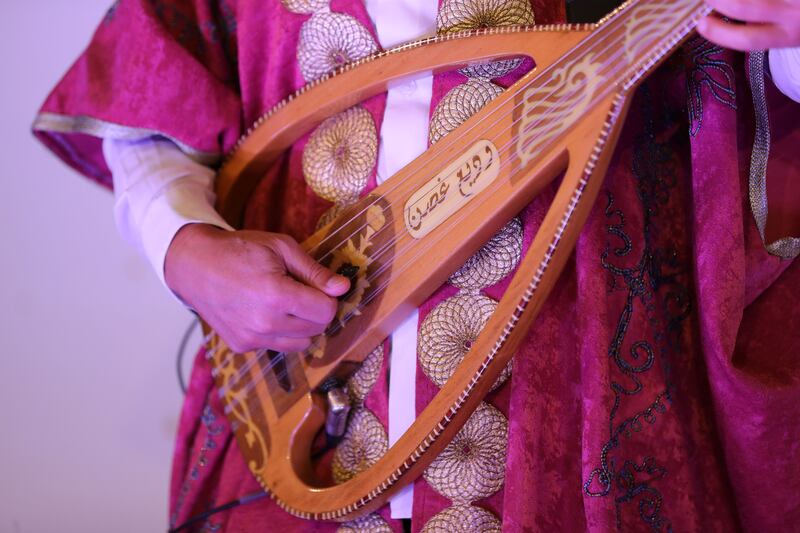 A musician plays oud at the Majlis of the World.