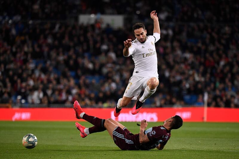 Real Madrid's Spanish defender Dani Carvajal jumps over Celta Vigo's Uruguayan defender Lucas Olaza. AFP