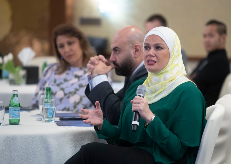 An attendee asking questions at the event in Dubai.